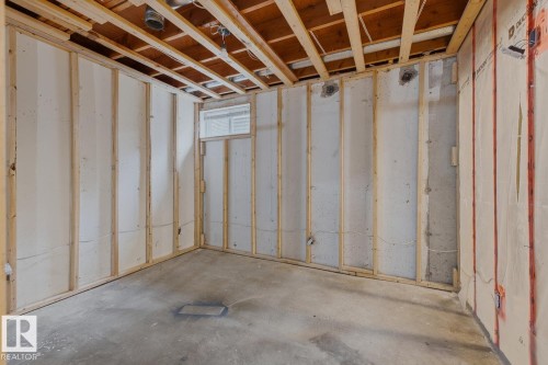 Unfinished basement with concrete flooring and exposed ceiling joists - 10621 Beaumaris Road Nw, Edmonton, AB 