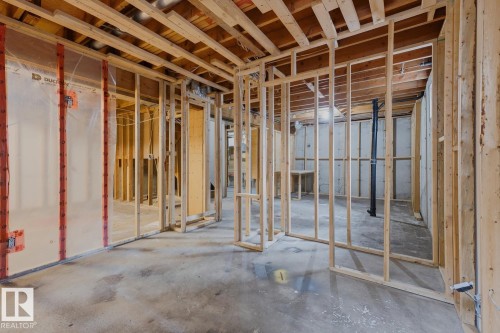 Unfinished basement featuring wood framing, concrete foundation walls, and concrete flooring - 10621 Beaumaris Road Nw, Edmonton, AB 