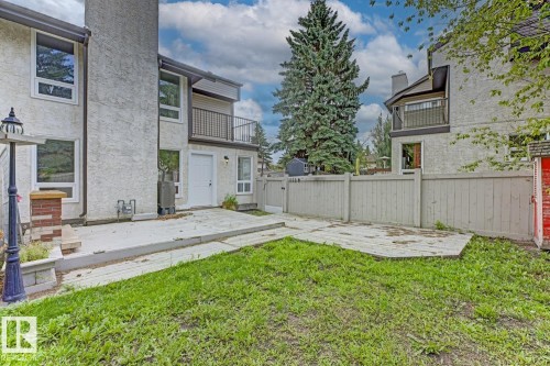 Private backyard with a concrete patio, wood deck, and fenced perimeter - 10621 Beaumaris Road Nw, Edmonton, AB 