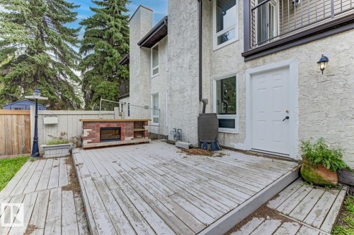 Outdoor deck with built-in brick fireplace and wood mantle - 10621 Beaumaris Road Nw, Edmonton, AB 