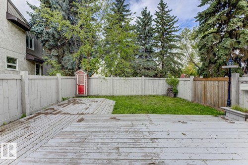Wood-finish deck with a grass area and perimeter fencing - 10621 Beaumaris Road Nw, Edmonton, AB 