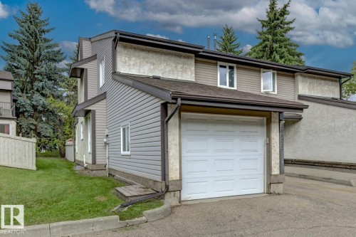 Attached garage with white panel door - 10621 Beaumaris Road Nw, Edmonton, AB 