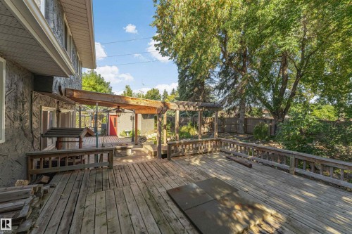 Multi-level wood deck with pergola, wood railings, and mature trees - 11208 163A Avenue Nw, Edmonton, AB 