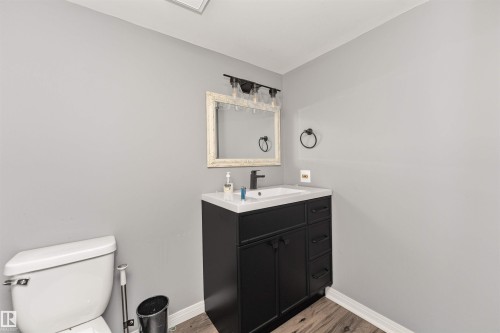 Modern vanity with a black cabinet, white countertop, and rectangular sink - 11208 163A Avenue Nw, Edmonton, AB 
