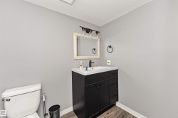 Modern vanity with a black cabinet, white countertop, and rectangular sink - 