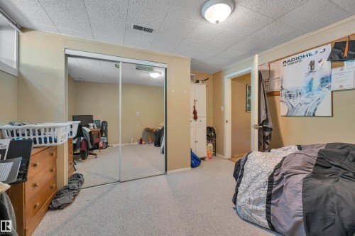 Mirrored closet doors, recessed ceiling light fixture, and light-toned carpeting - 8812 135A Avenue Nw, Edmonton, AB 