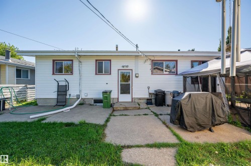 White vinyl siding exterior with multiple windows and a rear entry door - 8812 135A Avenue Nw, Edmonton, AB 
