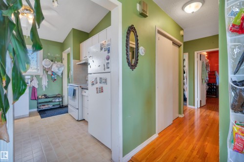 Kitchen with white cabinetry, tile flooring, and a window - 8812 135A Avenue Nw, Edmonton, AB 