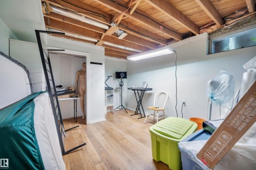 Wood-finish flooring with exposed ceiling joists and recessed window - 8812 135A Avenue Nw, Edmonton, AB 