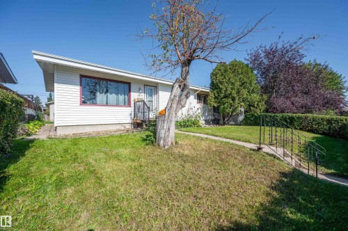 White exterior siding with red-framed front window - 8812 135A Avenue Nw, Edmonton, AB 