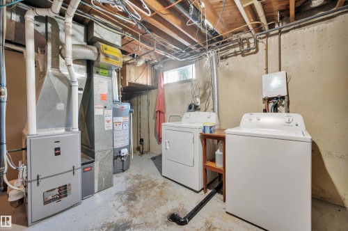 Laundry area with a washer and dryer, furnace, and water heater - 8812 135A Avenue Nw, Edmonton, AB 