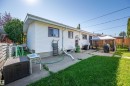 Fenced backyard featuring a concrete patio, a detached gazebo, and a grass lawn - 8812 135A Avenue Nw, Edmonton, AB 