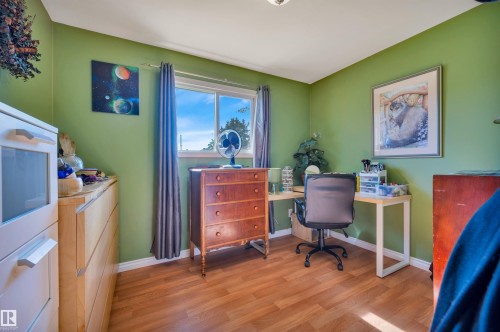 Wood-finish flooring with a neutral ceiling and a single window - 8812 135A Avenue Nw, Edmonton, AB 
