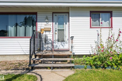 White siding exterior with contrasting maroon window trim - 8812 135A Avenue Nw, Edmonton, AB 
