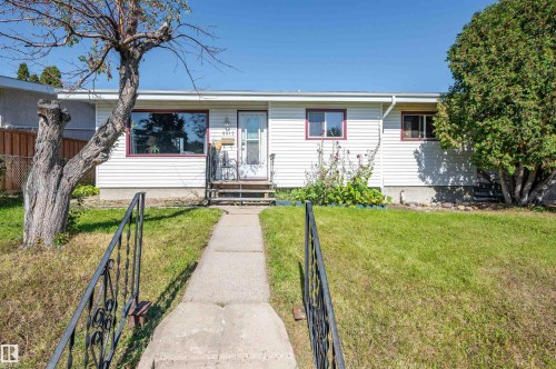 White horizontal siding exterior with red trim windows - 8812 135A Avenue Nw, Edmonton, AB 