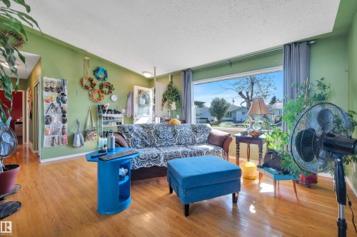 Wood-finish flooring throughout the living space - 8812 135A Avenue Nw, Edmonton, AB 