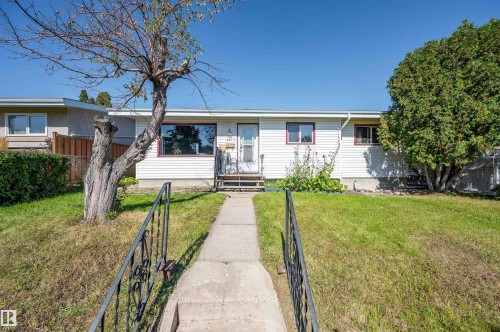 White exterior siding with red trim accents - 8812 135A Avenue Nw, Edmonton, AB 