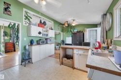 Kitchen featuring wood-finish flooring, white cabinetry, a built-in sink, and a glass-paneled exterior door - 