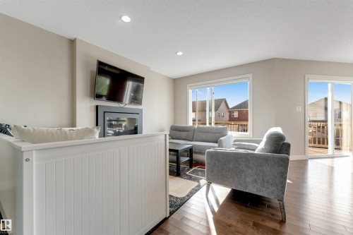Hardwood-finish flooring, recessed lighting, and large windows - 136 55 Street Sw, Edmonton, AB 