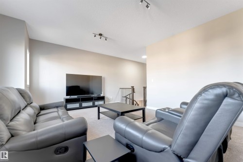 Neutral wall paint, ceiling-mounted track lighting, and soft carpet flooring - 136 55 Street Sw, Edmonton, AB 
