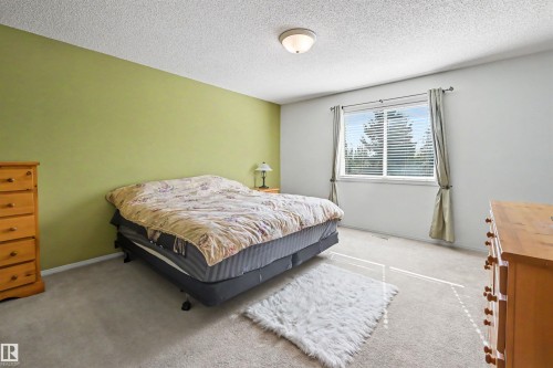 Wall-to-wall carpeting and a window with blinds provide a comfortable atmosphere - 8513 156 Avenue Nw, Edmonton, AB 