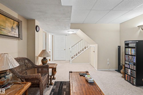Carpeted flooring, painted walls, overhead lighting, and a paneled ceiling - 8513 156 Avenue Nw, Edmonton, AB 