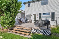 Expansive wood deck with lattice skirting, multiple steps, and a grassy yard - 