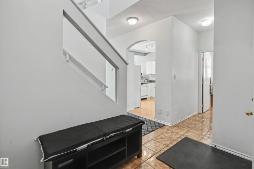 Tiled flooring in the entryway with white walls and overhead lighting - 8513 156 Avenue Nw, Edmonton, AB 