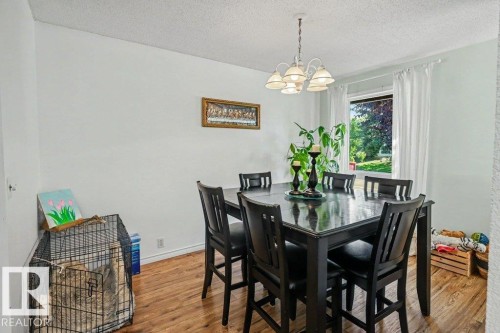 Wood-finish flooring, white walls, and a window providing natural light - 8708 25A Avenue Nw, Edmonton, AB 