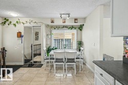 Tiled flooring extending throughout, window with horizontal blinds, built-in mirrored sliding closet doors, built-in white cabinetry, and recessed lighting - 