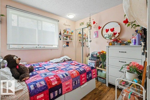 Wood-finish flooring with a flush-mount ceiling light fixture, and a window with roller blinds - 8708 25A Avenue Nw, Edmonton, AB 