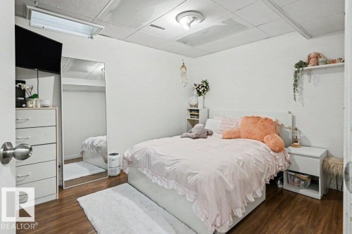 Wood-finish flooring with white walls - 8708 25A Avenue Nw, Edmonton, AB 