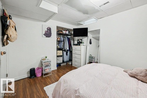Wood-finish flooring with a white area rug - 8708 25A Avenue Nw, Edmonton, AB 