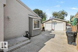 Detached garage with a double-width door and concrete driveway - 