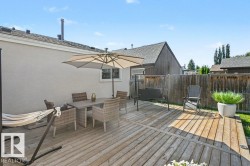 Expansive wood-finish deck with privacy fencing and a stucco exterior - 