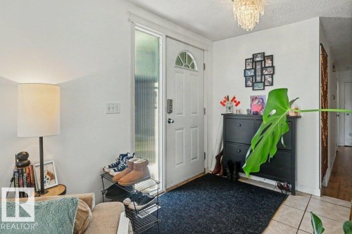 White paneled entry door with frosted glass sidelight - 8708 25A Avenue Nw, Edmonton, AB 