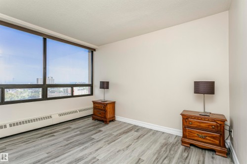 Expansive window offering broad outdoor scenery, light gray wood-finish flooring, and neutral wall paint - #815 10160 114 St Nw, Edmonton, AB 