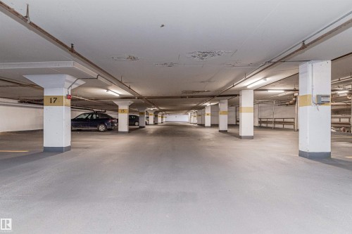 Underground parking garage featuring concrete flooring, structural support columns, and overhead fluorescent lighting - #815 10160 114 St Nw, Edmonton, AB 