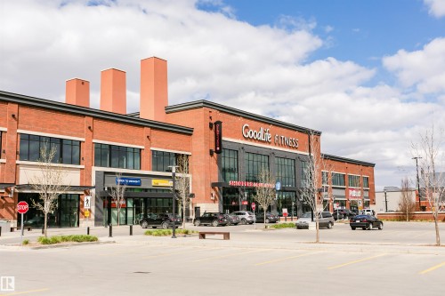 Brick facade building with large storefront windows and prominent signage - #815 10160 114 St Nw, Edmonton, AB 