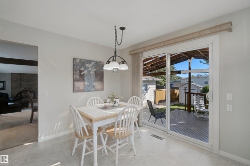 Eat-In Kitchen breakfast area with sliding glass door to the covered outdoor deck - 11439 144 Avenue Nw, Edmonton, AB 
