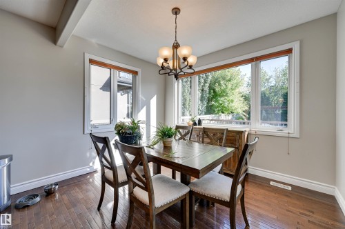 Hardwood flooring, painted walls, white trim, recessed beam ceiling detail, and a multi-pane window - 2203 Warry Loop Sw, Edmonton, AB 