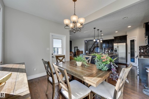 Hardwood-finish flooring, recessed lighting, and a modern chandelier - 2203 Warry Loop Sw, Edmonton, AB 
