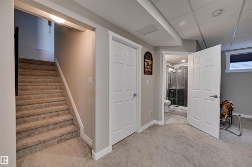 Finished lower level with neutral carpet flooring and painted walls - 2203 Warry Loop Sw, Edmonton, AB 