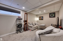 Recessed lighting, drop ceiling, neutral carpeting, and a window with blinds - 