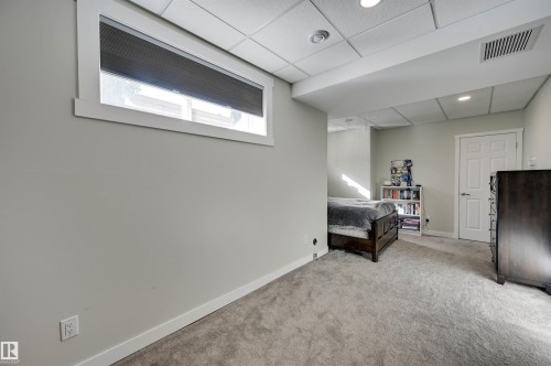 Recessed lighting illuminates the carpeted flooring and light-toned walls - 2203 Warry Loop Sw, Edmonton, AB 