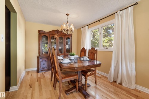 Hardwood flooring, overhead chandelier, and multiple windows with ample light - 30 Gariepy Crescent Nw, Edmonton, AB 