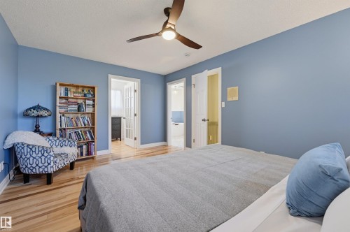 Hardwood-style flooring throughout, ceiling fan with integrated lighting, and multiple doorways - 30 Gariepy Crescent Nw, Edmonton, AB 