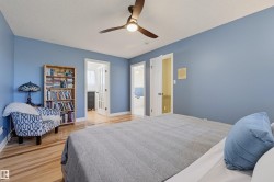 Hardwood-style flooring throughout, ceiling fan with integrated lighting, and multiple doorways - 
