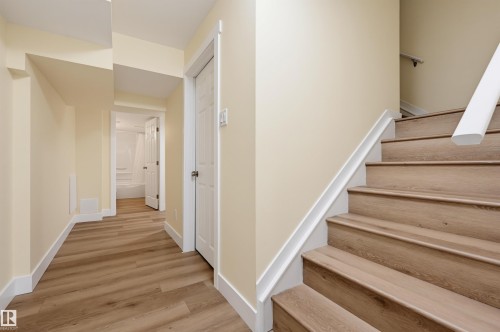Wood-finish flooring throughout, white trim, and light neutral wall colors - 30 Gariepy Crescent Nw, Edmonton, AB 