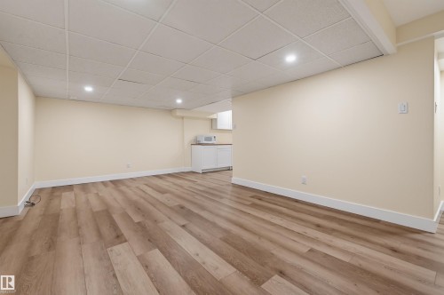 Recessed lighting, drop ceiling, wood-finish flooring, built-in cabinetry, and integrated sink - 30 Gariepy Crescent Nw, Edmonton, AB 